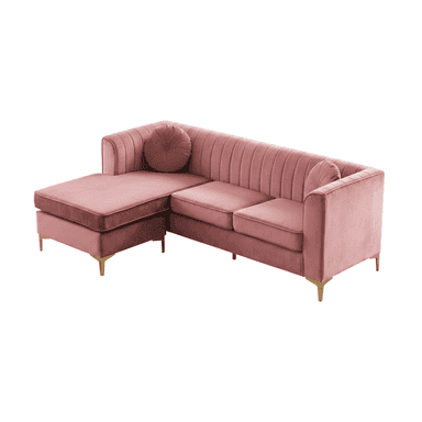 A modern L-shaped sectional sofa upholstered in blush pink velvet fabric, featuring a right-hand facing chaise lounge and distinctive vertical channel tufting on its backrest and arms. It is supported by slender, gold-finished metal legs and includes two round accent pillows. — 3D model (AI enhanced source)