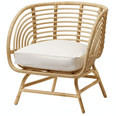 A light-colored rattan armchair with a curved back and armrests. It features a thick, white seat cushion. The frame is constructed from natural cane or bamboo, with woven details on the back and sides. The legs are also made of rattan and are angled outwards for stability. — 3D model (AI enhanced source)