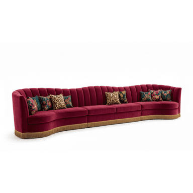 A luxurious and expansive curved sectional sofa upholstered in deep red velvet, featuring a distinctive channel-tufted backrest and a decorative gold-toned fringe trim along its base. The sofa is composed of multiple curved segments that form a continuous, sweeping line. It is adorned with several throw pillows in contrasting patterns, including leopard print and floral designs, adding to its opulent aesthetic. — 3D model (AI enhanced source)