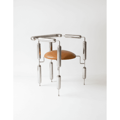A striking postmodern accent chair featuring a highly polished tubular chrome frame and a circular, tan upholstered seat. The frame is constructed from segmented chrome tubes connected by smaller rods and spherical joints, creating a unique, sculptural silhouette. The design is minimalist yet highly stylized, resembling an avant-garde artistic creation with functional seating. The seat appears to be made of leather or a high-quality leatherette. — 3D model (AI enhanced source)