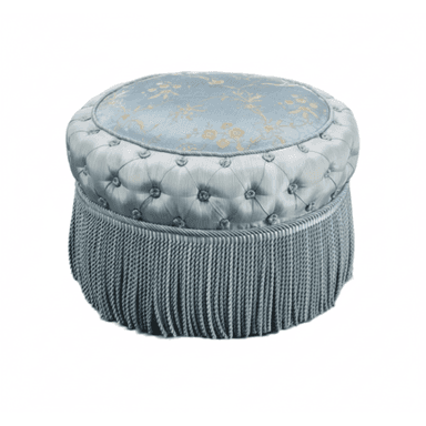 A round, upholstered ottoman featuring a light blue damask-patterned top surface, deeply tufted sides in a solid light blue fabric, and a long, matching light blue tassel fringe around its base. — 3D model (AI enhanced source)