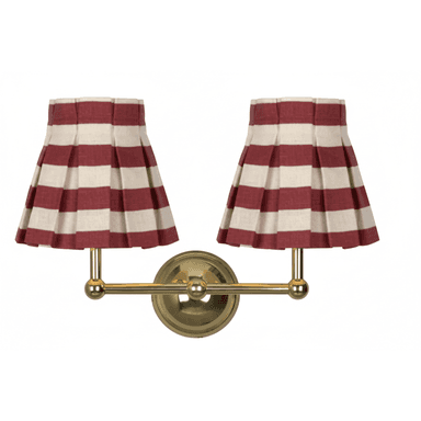 A double-armed wall lamp with two pleated lampshades featuring a horizontal stripe pattern of red and off-white. The lamp base and arms are constructed of polished brass. — 3D model (AI enhanced source)