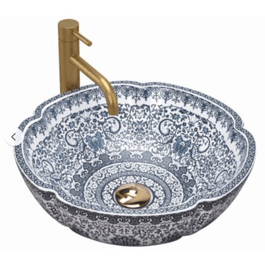 A decorative round ceramic vessel sink featuring an intricate blue and white chinoiserie pattern and a scalloped rim, paired with a tall, matte brass single-handle faucet. — 3D model (AI enhanced source)