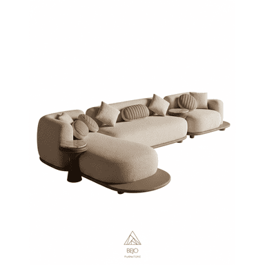 A contemporary modular sectional sofa featuring a curvilinear design and composed of multiple upholstered sections. It is finished in a light beige, textured fabric and rests upon a low, continuous dark brown platform base. The sofa includes two integrated round side tables, one with a marble top and the other with a wooden top, seamlessly blending into the design. It is adorned with several matching throw pillows, including square and fluted cylindrical shapes. — 3D model (AI enhanced source)