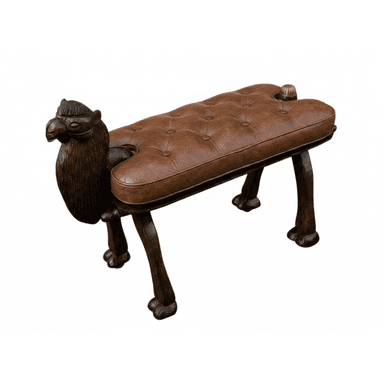 An elaborately crafted bench featuring a carved wooden camel head at one end and a brass finial at the other. The elongated seat is upholstered in rich brown tufted leather. The four legs are carved to resemble animal paw feet, and the entire wooden structure is finished in a dark stain, suggesting a historical or exotic design influence. — 3D model (AI enhanced source)