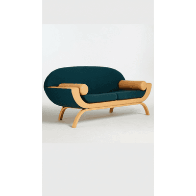 A contemporary loveseat featuring a gracefully curved bentwood frame with dark teal fabric upholstery and tan cylindrical bolster pillows. The frame wraps around the back and sides, creating an integrated shell. — 3D model (AI enhanced source)