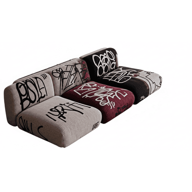 A modular sofa composed of three distinct seating units, upholstered with a textured fabric. The upholstery features a prominent graphic design resembling graffiti in black, white, and red hues, applied across all sections. The sofa has a low profile and blocky construction. — 3D model (AI enhanced source)