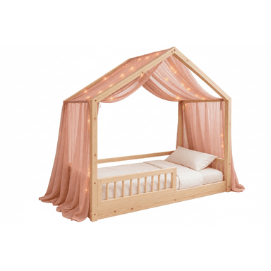 A children's bed featuring a house-shaped frame constructed from light-colored pine wood. It is adorned with a sheer pink fabric canopy and integrated string lights. The bed has a low-to-the-ground platform design and includes a partial safety rail on one side. — 3D model (AI enhanced source)