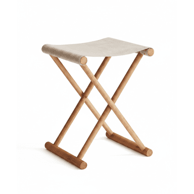 A lightweight, portable folding stool featuring an X-frame design crafted from light-toned wood. The seat is a piece of beige or off-white canvas fabric stretched between the top wooden bars, creating a comfortable sling-like surface. The construction allows the stool to collapse for easy storage and transport. — 3D model (AI enhanced source)