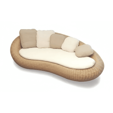 A contemporary outdoor daybed featuring an organic, kidney-bean shape. The base is constructed from woven synthetic rattan or natural wicker in a light brown hue. It is topped with a custom-fitted, off-white or cream-colored mattress, providing a comfortable lounging surface. Several loose throw pillows in complementary beige and cream tones are arranged along one curved edge, serving as a flexible backrest. The design suggests a relaxed, resort-style aesthetic, suitable for outdoor living spaces. — 3D model (AI enhanced source)
