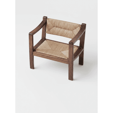 An armchair constructed with a dark-stained solid wood frame and natural woven rush for both the seat and backrest. The frame features a robust, rectilinear design with wide, flat armrests, and the woven material provides a textured surface. — 3D model (AI enhanced source)