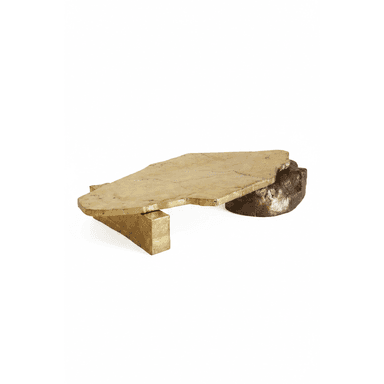 A low-profile coffee table featuring an irregularly shaped top and two distinct supports, crafted from brass and bronze. The top surface is a golden-toned, organic slab with a textured, mottled appearance. One support is a block-like form, also golden, while the other is a darker, naturalistic, rock-like bronze element. The design emphasizes raw, sculptural forms and contrasting metallic finishes. — 3D model (AI enhanced source)