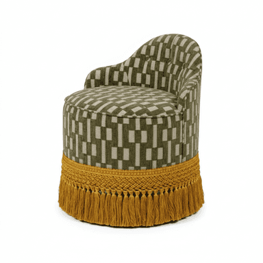 A compact, fully upholstered barrel-shaped chair featuring a low, rounded backrest that seamlessly merges into the seat. The chair is covered in a woven fabric with a geometric pattern in olive green and light beige/grey. Its base is adorned with a prominent mustard yellow braided trim and a voluminous tassel fringe. — 3D model (AI enhanced source)