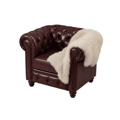 A classic Chesterfield-style armchair, upholstered in rich burgundy leather, featuring deep button tufting on the backrest and rolled arms, and detailed with brass nailhead trim along the front edges and base. The chair sits on dark, turned wooden feet. A cream-colored faux fur throw blanket is draped over one arm and part of the seat. — 3D model (AI enhanced source)