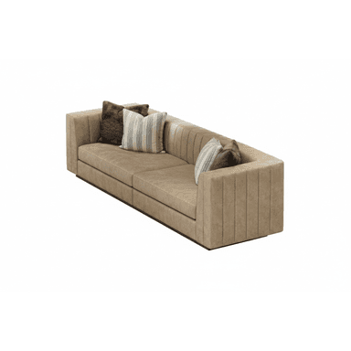 A contemporary two-seater sofa with tan upholstered fabric, characterized by vertical channel tufting on its exterior and solid track arms. It sits on a recessed plinth base, giving it a low-profile appearance. Two decorative throw pillows, one striped and one textured brown, are placed on the sofa. — 3D model (AI enhanced source)