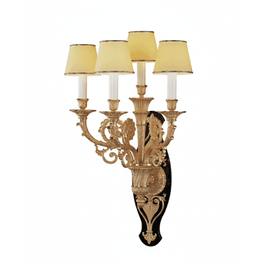 A decorative wall sconce featuring an ornate gilded metal structure with five candle-style lights. The sconce has a black backing plate with intricate gold detailing. Each light is topped with a pale yellow fabric shade with a dark trim. — 3D model (AI enhanced source)