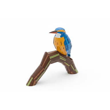A decorative sculpture depicting a kingfisher bird perched on a branch, crafted from multiple segmented pieces of wood. The bird features a vibrant blue, orange, and white palette, while the branch is predominantly brown with green and lighter brown accents, all finished with a smooth, glossy appearance. — 3D model (AI enhanced source)