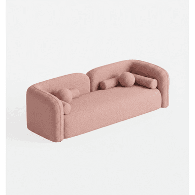 A contemporary, three-seater sofa characterized by its curvilinear form and plush bouclé upholstery. It features low, continuously rounded armrests and backrest, creating a seamless, sculptural silhouette. The sofa is finished in a light pink bouclé fabric and includes two cylindrical bolster pillows and one spherical accent pillow, all upholstered in the same material. — 3D model (AI enhanced source)