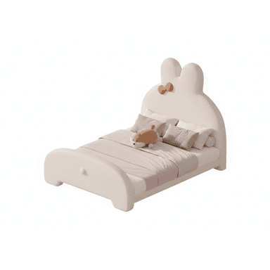 A children's bed with a playful, cartoonish design, featuring a headboard shaped like a rabbit's ears and a decorative bow. The bed frame is low-profile and rounded, with a simple footboard. It is furnished with bedding, including pillows and a blanket, and a small stuffed animal. — 3D model (AI enhanced source)