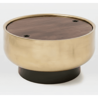 A round coffee table with a wood-grain effect tabletop and a brushed brass-finished cylindrical body, supported by a dark, circular base. The tabletop has two small, recessed black circular elements, possibly for lid attachment or decorative purposes. — 3D model (AI enhanced source)