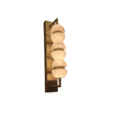 A contemporary wall-mounted light fixture, characterized by a rectangular brass backplate and a vertical column of six spherical alabaster diffusers. Each diffuser is composed of two half-spheres separated by a narrow gap, held in place by slim brass rings, creating a layered, luminous effect. The light emanates a soft, warm glow through the translucent alabaster. — 3D model (AI enhanced source)