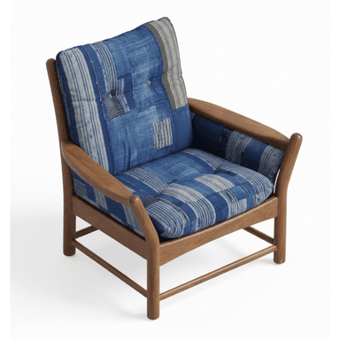 A lounge chair featuring a sturdy wooden frame with rounded armrests and plush, button-tufted cushions upholstered in a distinctive blue patchwork textile. — 3D model (AI enhanced source)