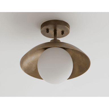 An aged brass semi-flush mount ceiling light featuring a curved, bowl-shaped brass shade that partially encloses a spherical opal glass diffuser. The fixture is mounted to the ceiling via a circular canopy and a short stem, allowing the light to extend slightly from the ceiling plane. The brass exhibits a brushed or antiqued finish, contributing to a vintage yet modern aesthetic. The design is minimalist, focusing on geometric shapes and material contrast. — 3D model (AI enhanced source)