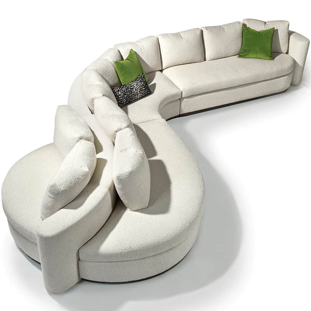 A large, modular, sectional sofa with a curved, organic silhouette. It features a textured, off-whit… — free GLTF 3D model