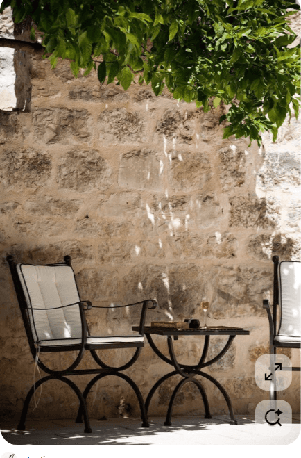 A black wrought iron outdoor armchair featuring a robust metal frame with curved legs and armrests,… — 3D model