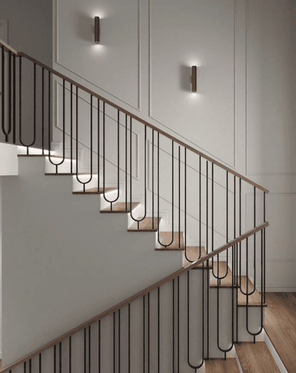 A pair of modern cylindrical wall sconces, likely made of metal with a brass or bronze finish, provi… — 3D model