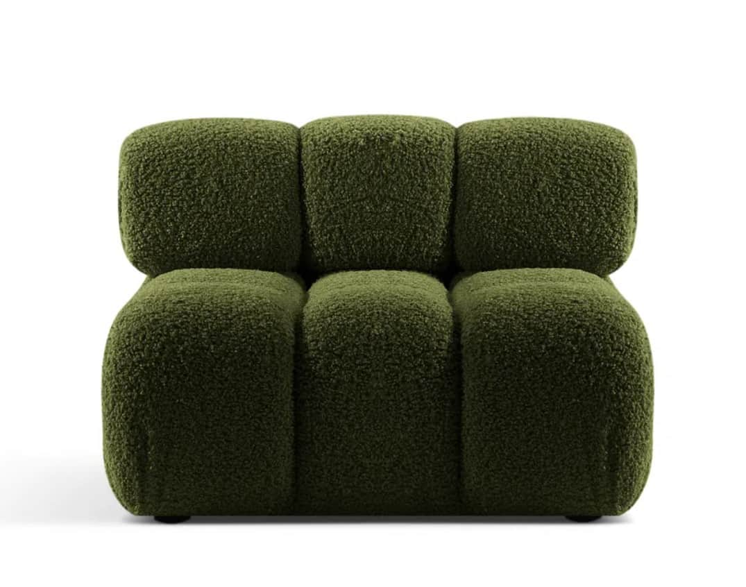A modern armchair upholstered in a textured, shaggy fabric. It features a modular design with rounde… — 3D model
