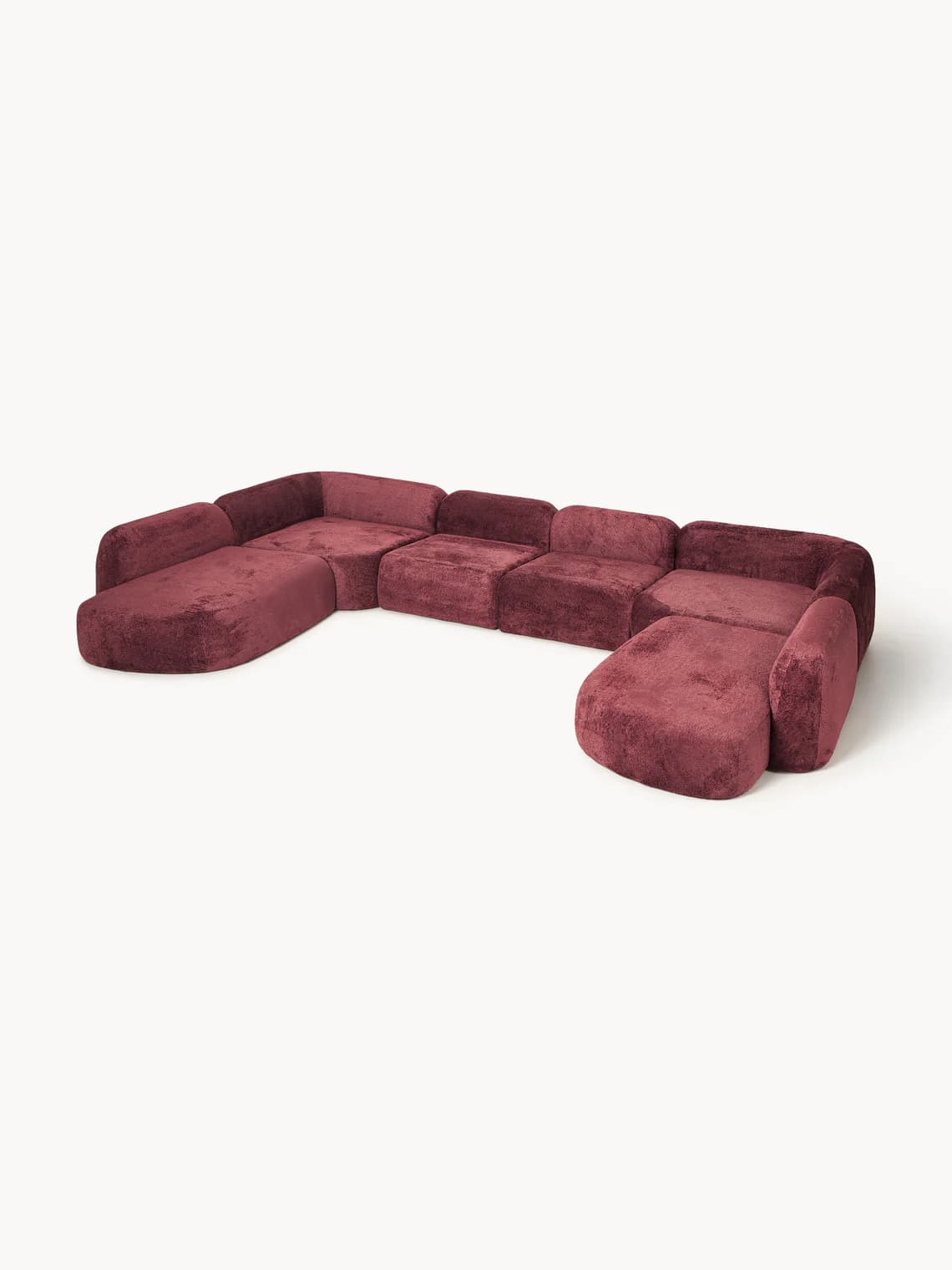 A modular sectional sofa with a U-shaped configuration. It features plush upholstery and rounded armrests and edges. The configuration consists of multiple connected seating modules, including corner pieces and possibly chaise elements, forming a large seating arrangement. — 3D model