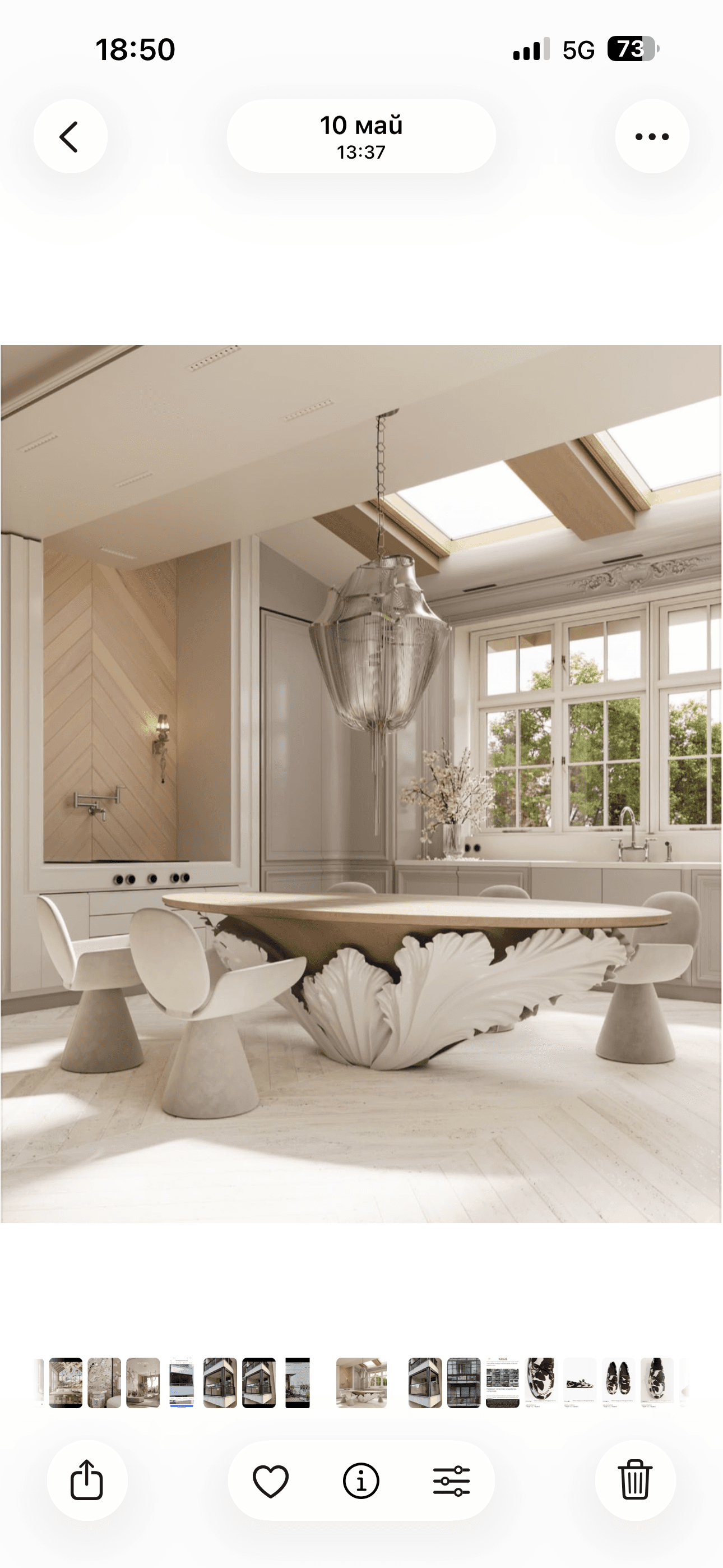 An oval-shaped coffee table featuring a light-toned wood tabletop and a distinctive, sculptural white base. The base has an organic, leaf-like or petal-like design, giving it a unique and artistic appearance. The table stands on a clean white background, highlighting its contemporary and elegant form. — 3D model