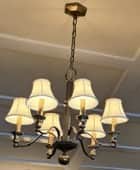 A traditional six-light chandelier featuring a two-tone metal finish with bronze and gold accents. S… — 3D model