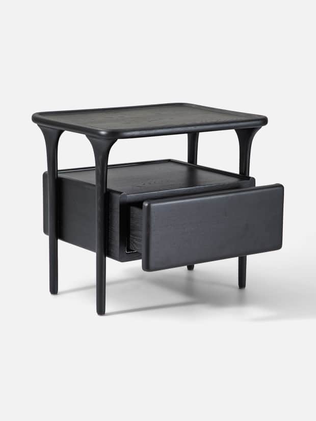 A modern nightstand crafted from black stained wood, featuring a rectangular top with subtly rounded… — 3D model