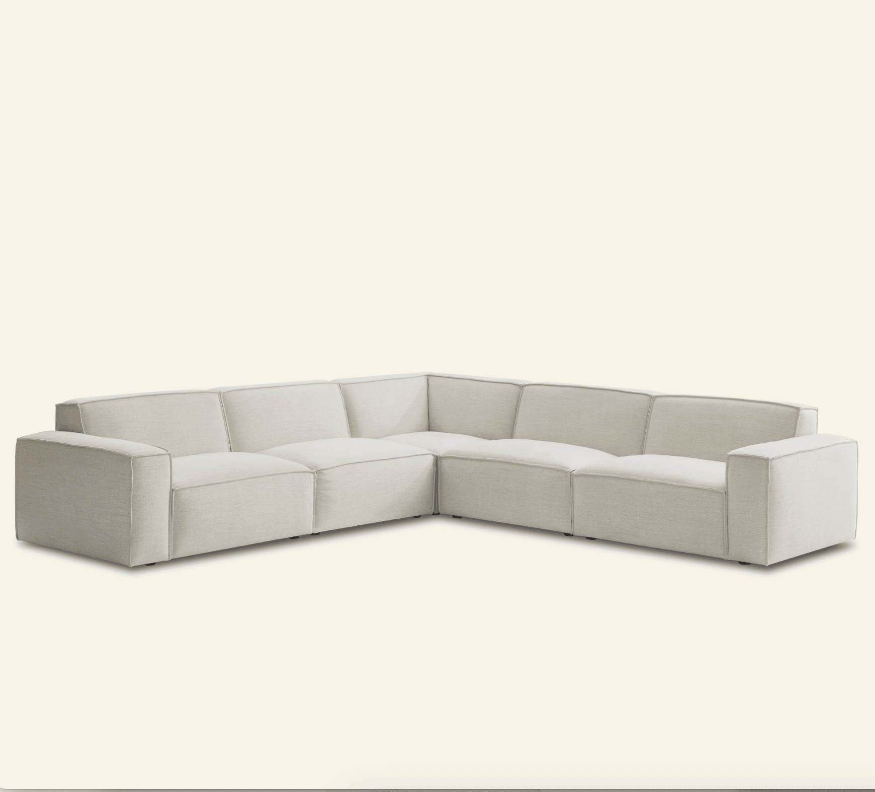 An L-shaped modular sectional sofa featuring multiple upholstered sections, including two end pieces with track arms and several armless middle and corner sections, all covered in a light-colored, possibly linen or cotton blend fabric with subtle piping details. — 3D model