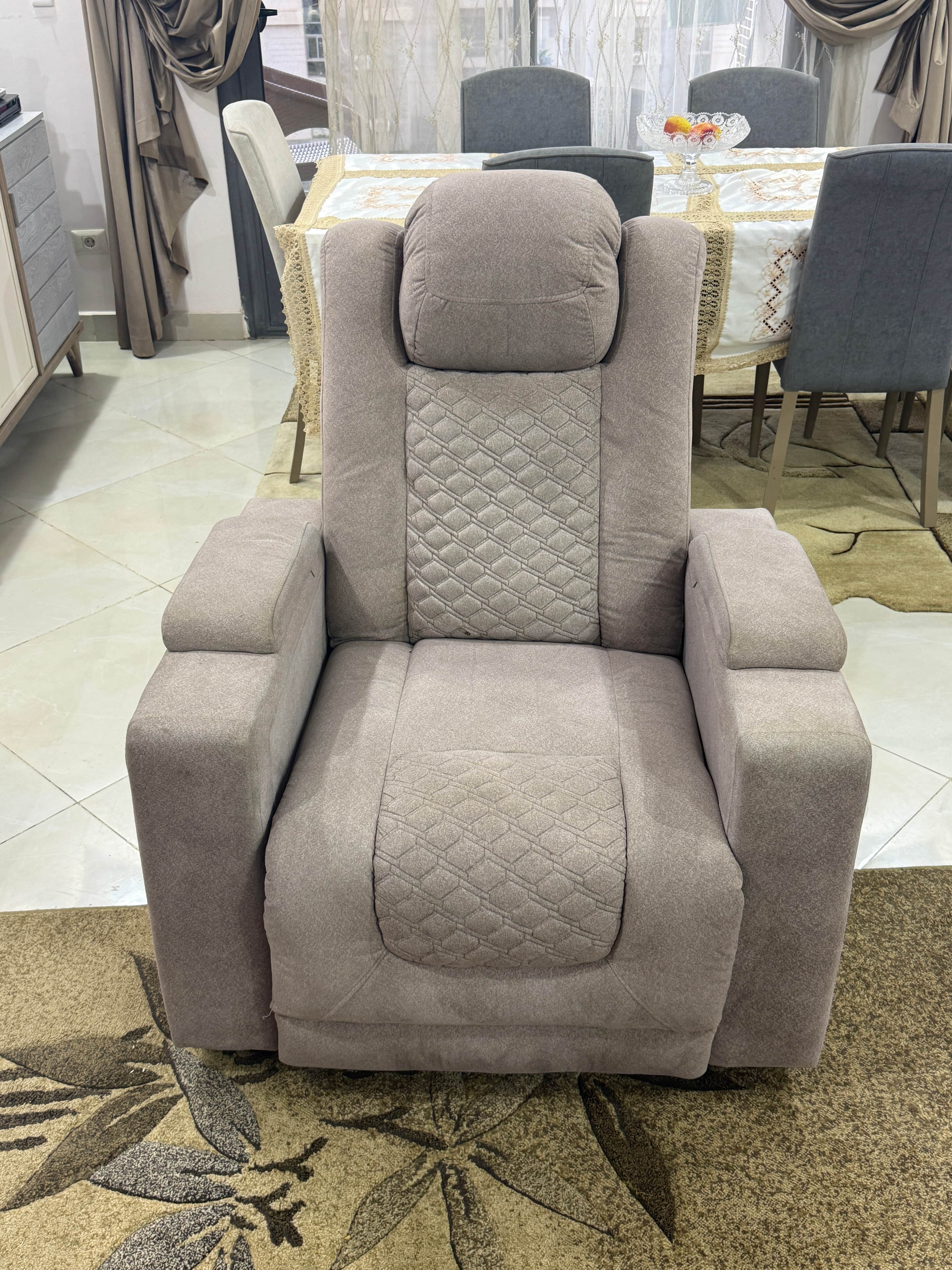 A light grey, upholstered, single-seat reclining chair with quilted accents on the backrest and seat… — 3D model