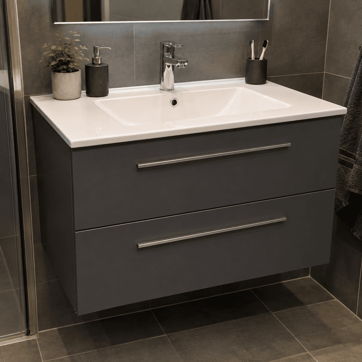 A modern wall-mounted bathroom vanity featuring a dark grey cabinet, a white integrated sink, and a… — free GLTF 3D model