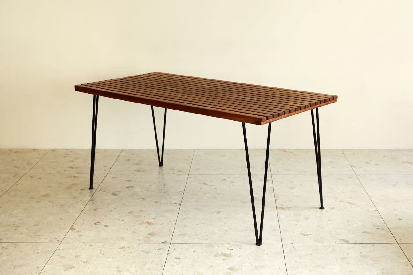 A rectangular coffee table featuring a top constructed from uniformly spaced wooden slats, supported by four slender black metal hairpin legs. — 3D model