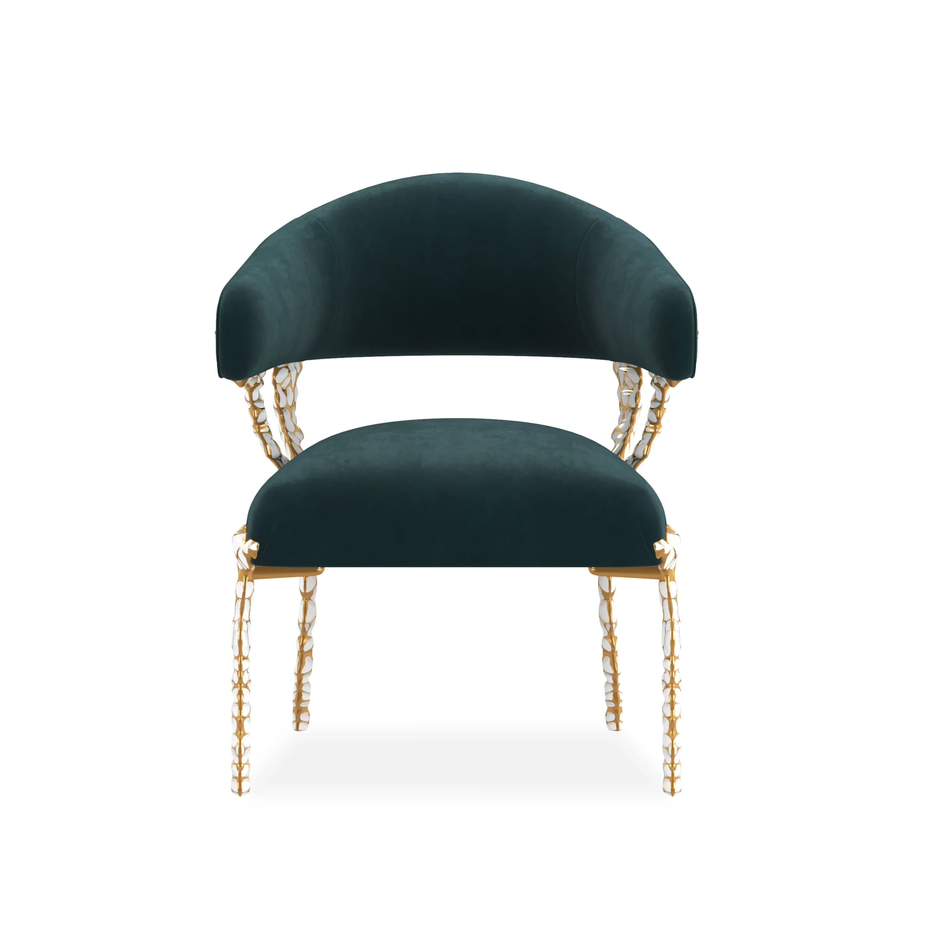 A luxurious barrel-style armchair upholstered in dark teal velvet, featuring an ornate frame with gold-finished metallic sections and sculptural white bone-like embellishments on the arm supports and slender legs. — 3D model