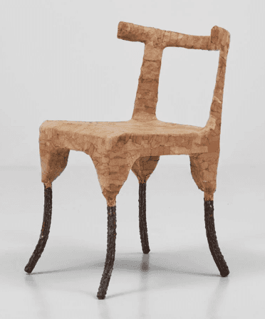 A unique, organically shaped chair with a textured surface. The seat and backrest appear to be const… — 3D model