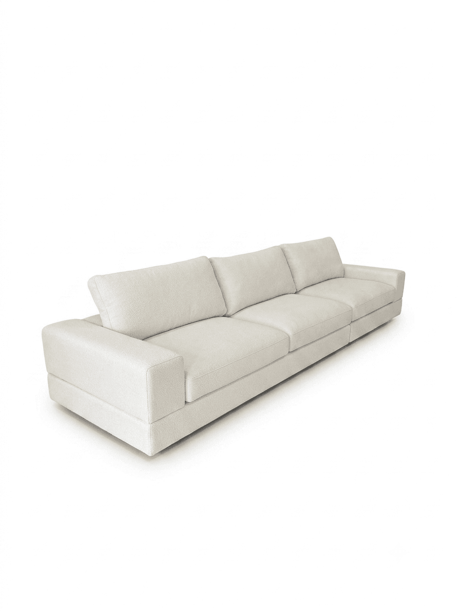 A long, contemporary sectional sofa featuring a low-profile design and generous proportions. It is upholstered in a light-colored, textured fabric with multiple deep seat cushions and plush backrests. The sofa includes wide, squared armrests, contributing to its modern and minimalist aesthetic. — 3D model