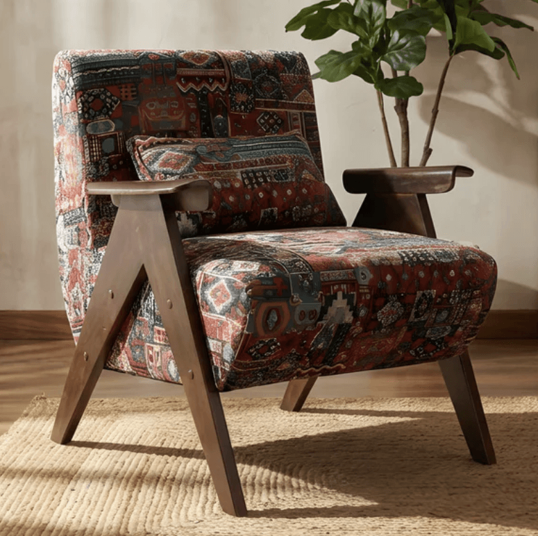 An upholstered lounge chair featuring a distinctive Kilim-style fabric pattern and an exposed dark-stained wooden frame. The chair has a comfortable, reclined posture, with broad wooden armrests and splayed legs. A small, matching lumbar pillow is included. — 3D model