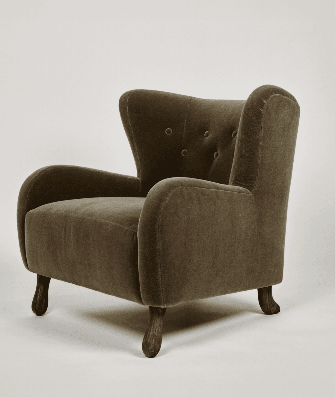An upholstered wingback armchair featuring a high backrest with button tufting, gently rolled arms,… — 3D model