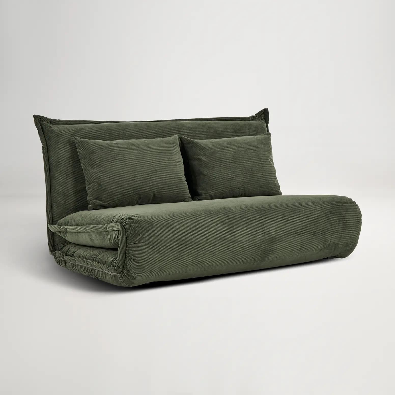 A convertible sofa bed upholstered in dark green corduroy fabric. The piece features a low profile with a rolled armrest/base and a fold-out mattress configuration. It includes two rectangular throw pillows that match the upholstery. — 3D model
