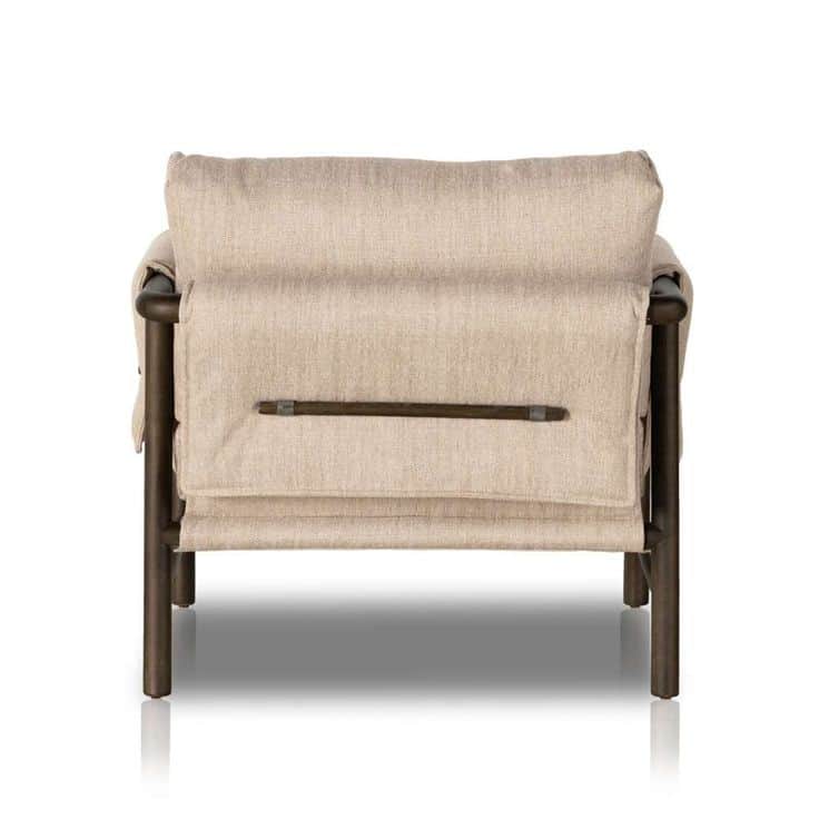 A modern lounge chair featuring an exposed dark-finished metal or wood frame supporting thick, light… — 3D model