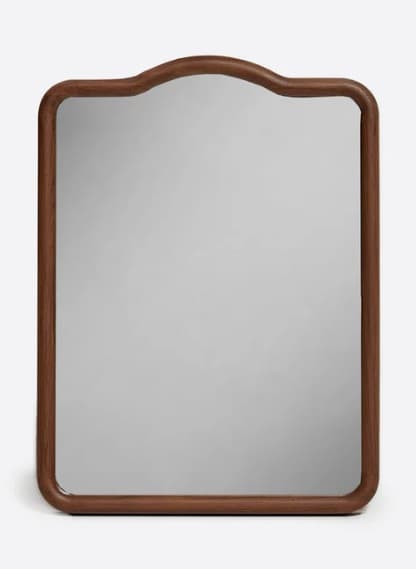 A rectangular mirror with a decorative curved top edge and rounded corners. It is framed by a substantial wooden border with a visible grain. — 3D model