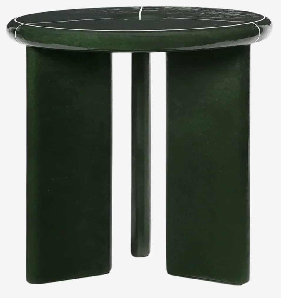 A dark green, round-top stool with three distinctive legs. The top surface features a striking white… — 3D model