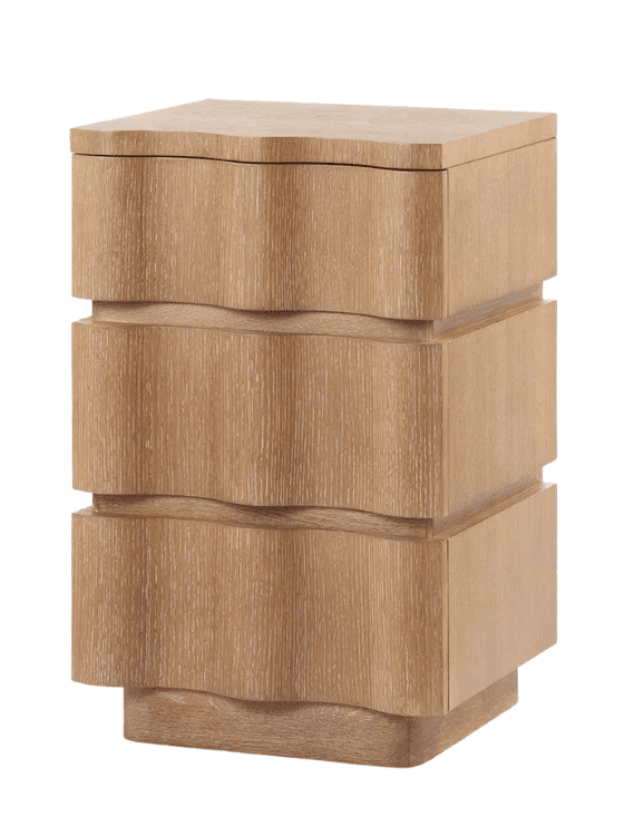 A contemporary three-drawer nightstand featuring distinctive wavy drawer fronts. The piece is constructed from light-toned wood with a visible grain, suggesting an oak or similar light wood finish. Its design incorporates a solid base and a slightly curved top edge that echoes the undulating lines of the drawers, providing a cohesive and organic aesthetic. The lack of visible hardware enhances its minimalist and sculptural appearance. — 3D model