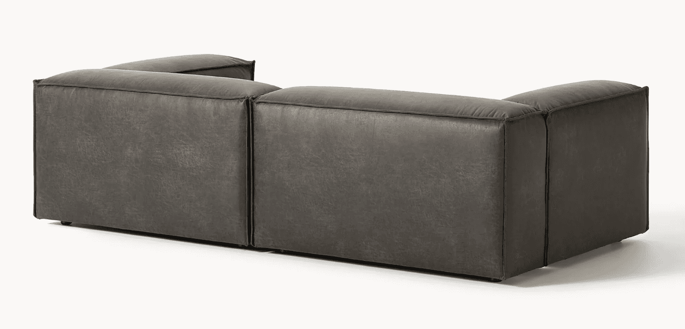 A dark grey modular sectional sofa, upholstered in distressed faux leather, featuring a low profile… — 3D model